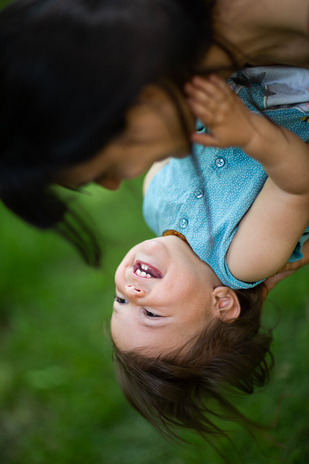 Bambina a testa in giù tra le risate