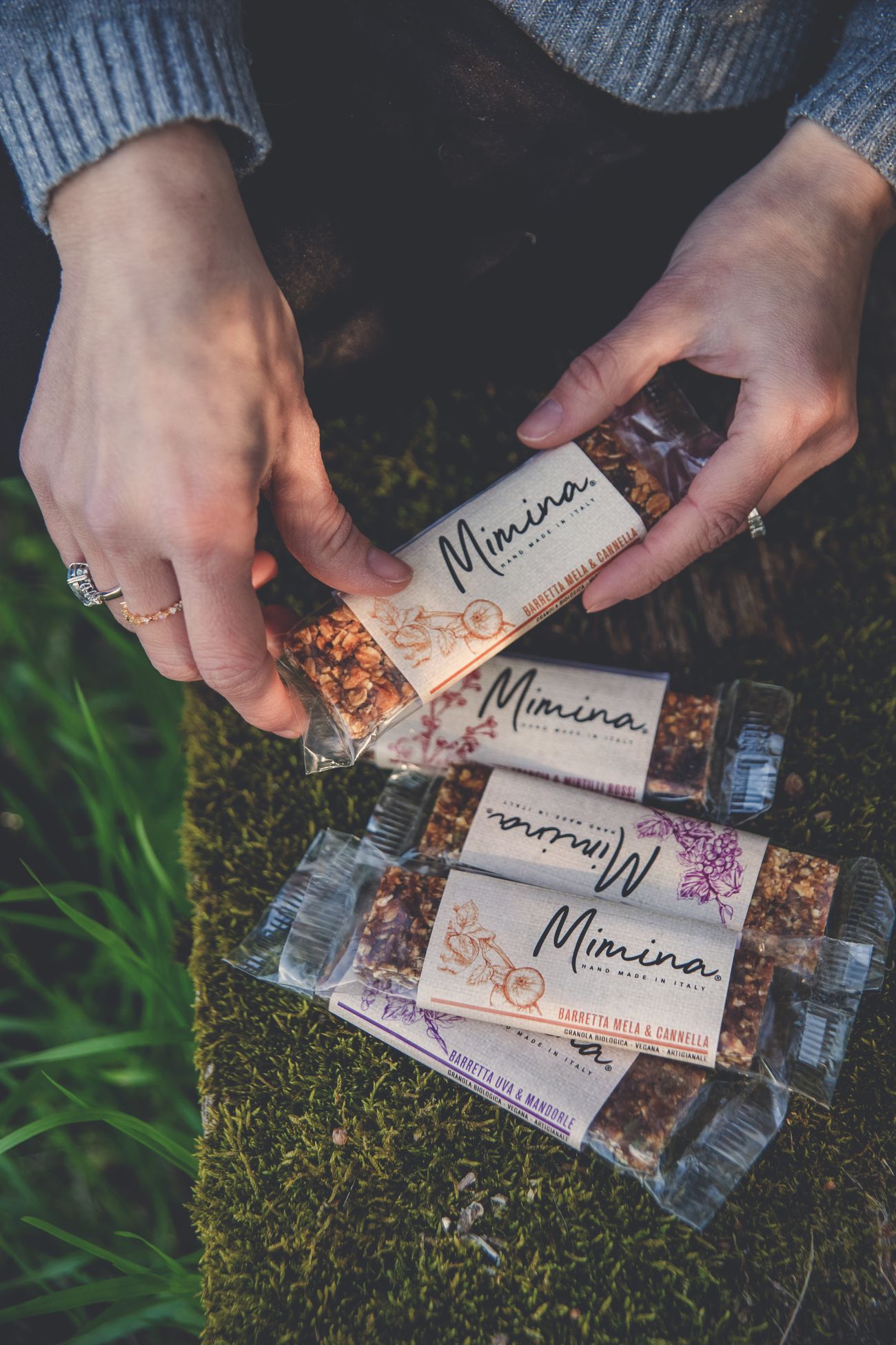 Le barrette di granola nelle mani, appoggiate sul muschio