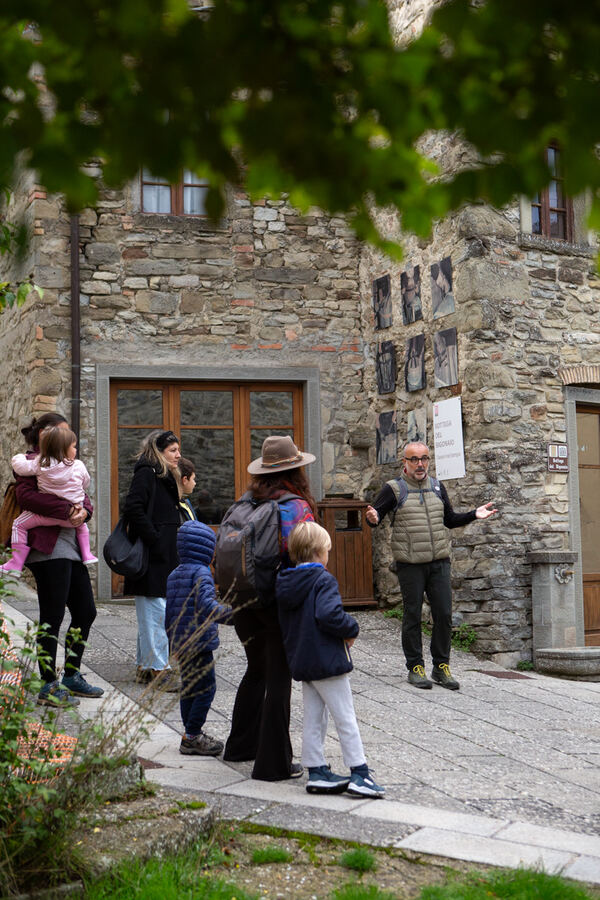 Il gruppo in visita ascolta la guida davanti alla bottega dei bigonai a Moggiona